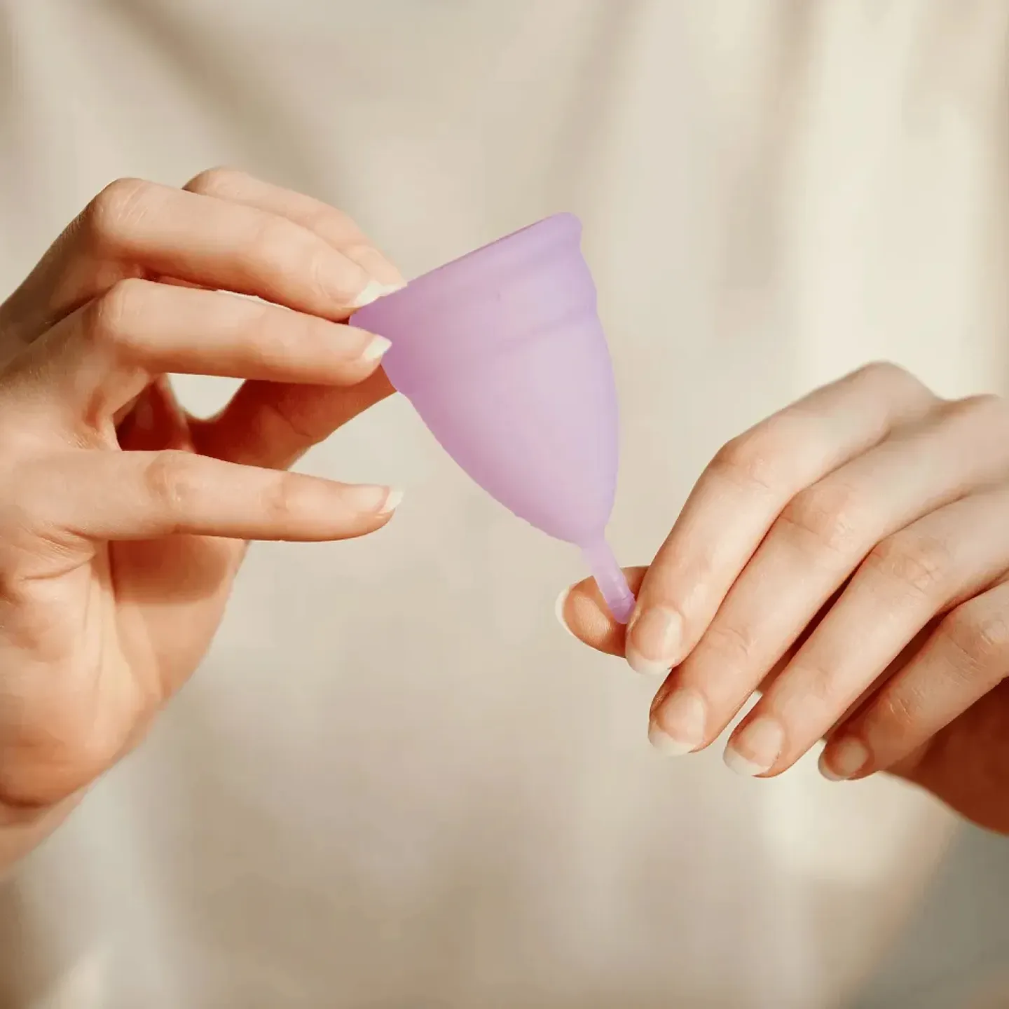 Woman holding a menstrual cup.