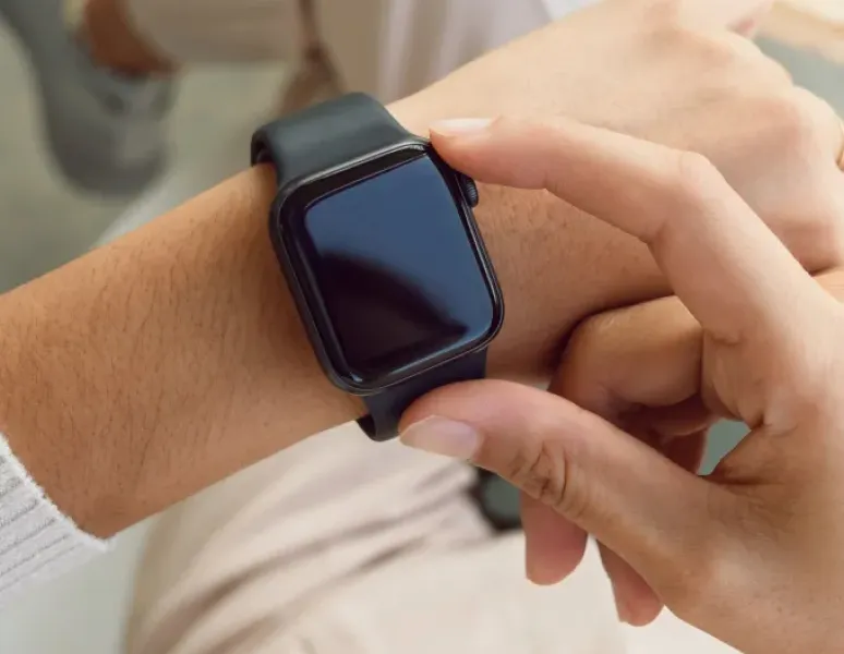 Person wearing an Apple Watch wearable, representing How to Use Health Trackers for Pelvic Health.