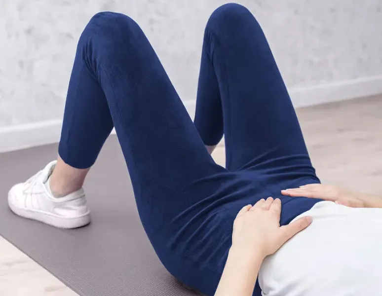 Woman with PMOS (PCOS) doing physical therapy exercises to help manage PMOS (PCOS) pain naturally.