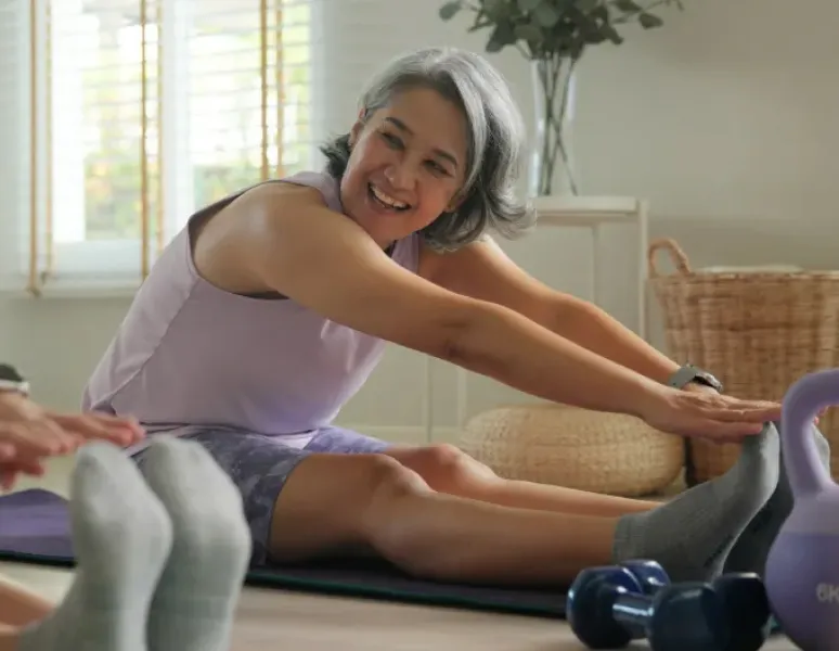 Woman in midlife who is exercising to support her longevity and pelvic and musculoskeletal health.