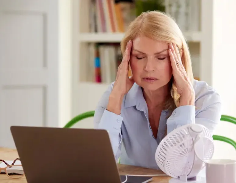 Woman experiencing menopause symptoms.