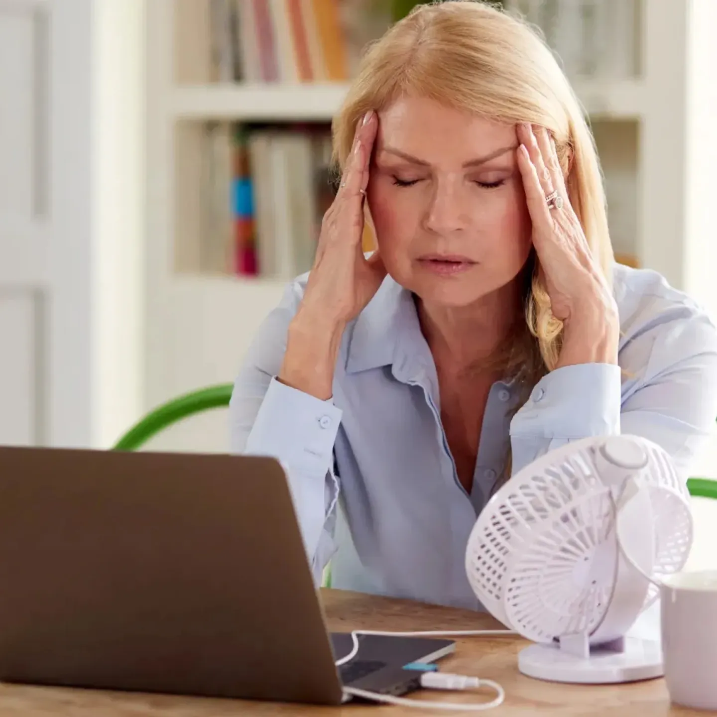 Woman experiencing menopause symptoms.