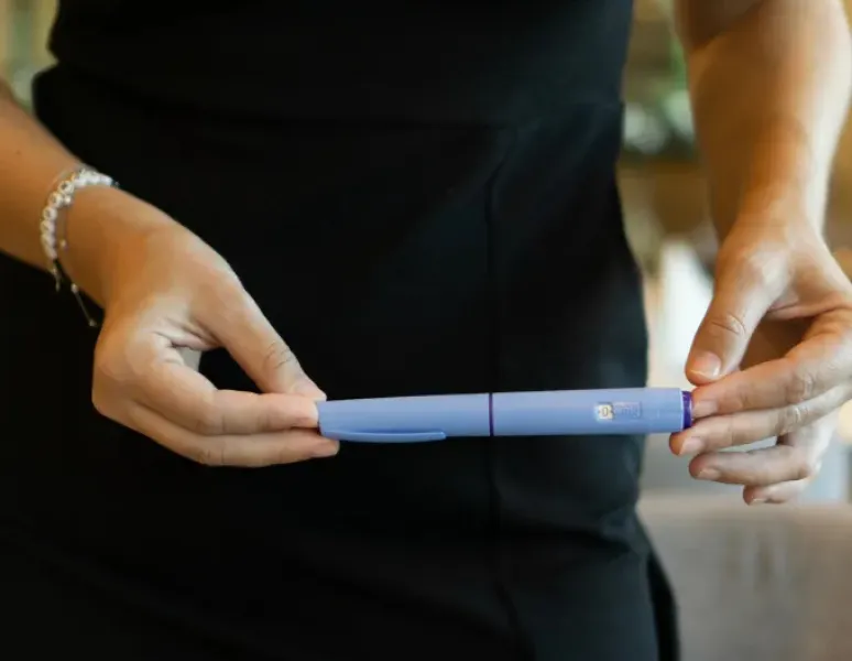 Woman holding GLP1 representing Ozempic for fertility.