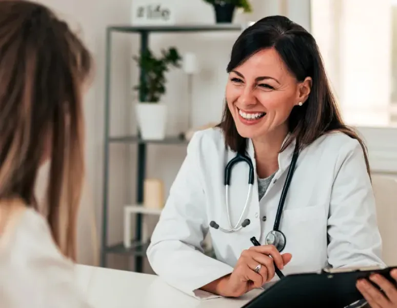 Primary care physician with her patient talking about pelvic health.