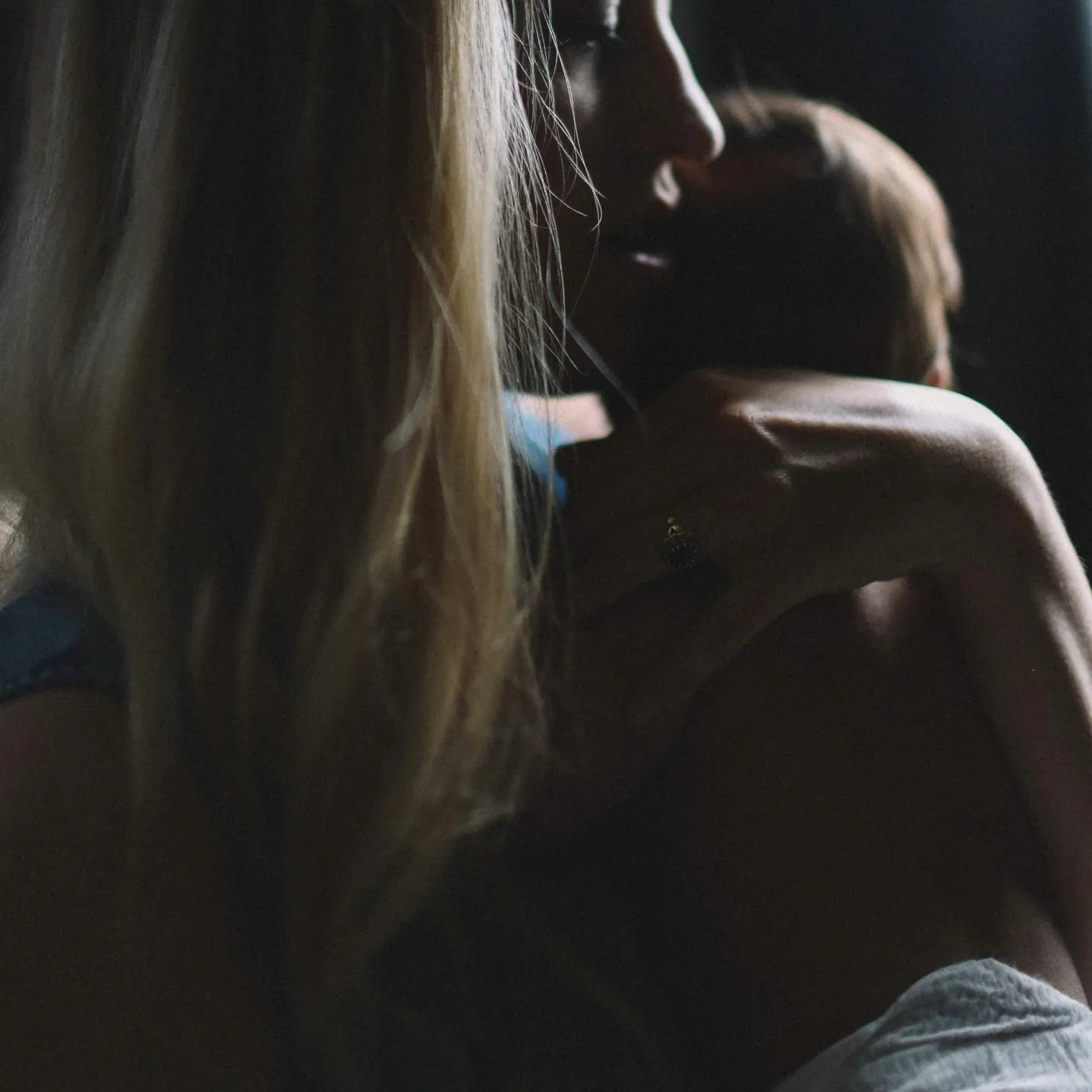 Postpartum woman with newborn representing postpartum hormone changes and mental health in the fourth trimester.