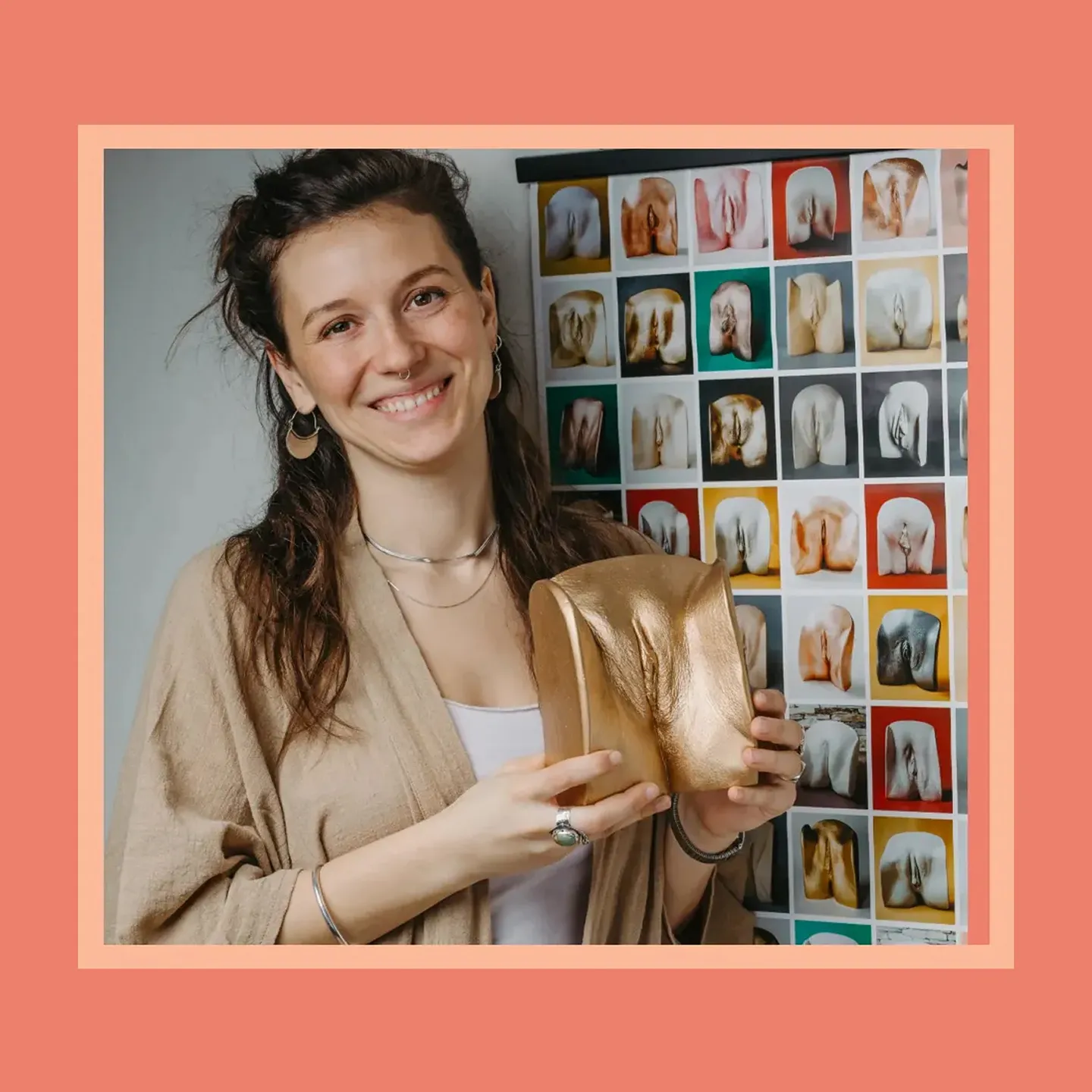 Vulva caster Viktoria Krug holds one of her golden vulva statues.