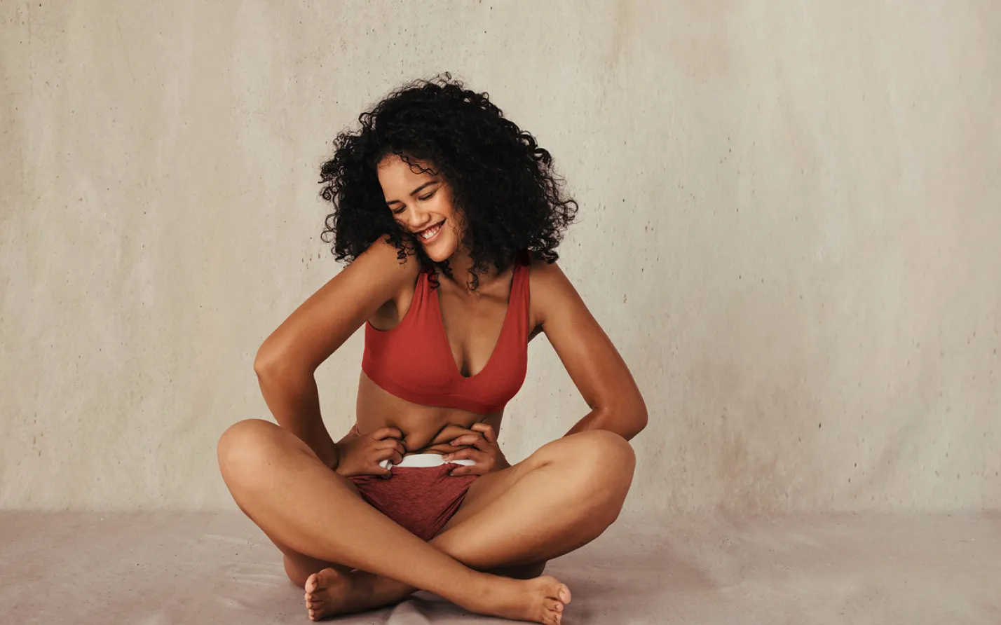 A woman smiling after doing pelvic floor physical therapy exercises.