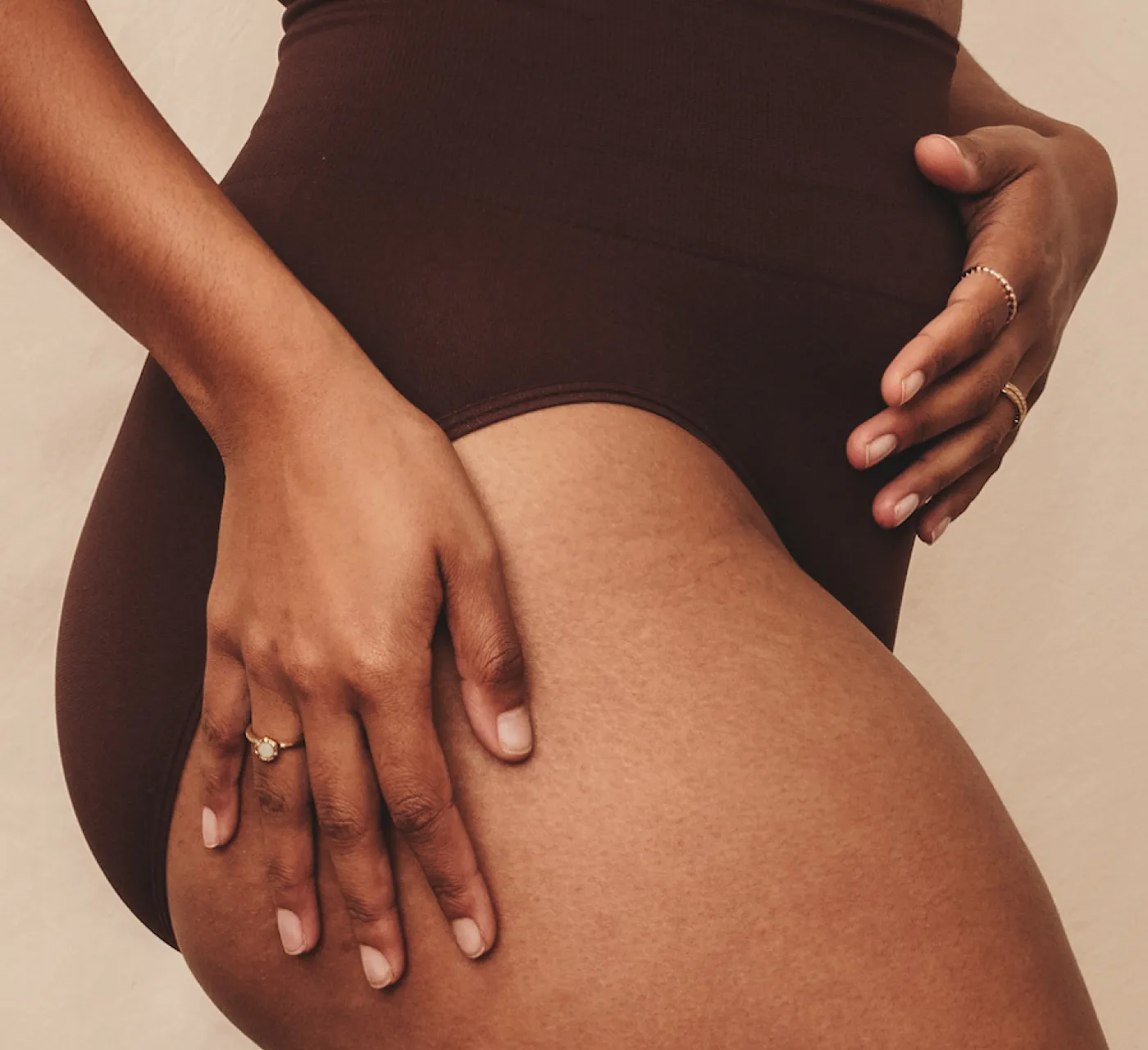 A woman with pelvic organ prolapse holding her abdomen.