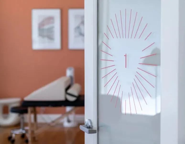 A door leading into a spa-like treatment room at Origin Physical Therapy in Towson, MD.