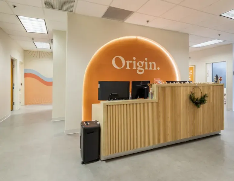 The welcoming and stylish front desk at Origin Physical Therapy in South Austin, TX.