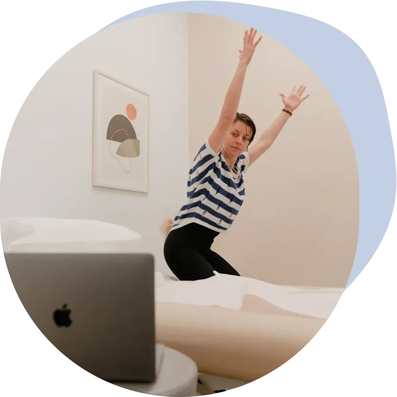 An Origin physical therapist demonstrating an exercise during a virtual visit.