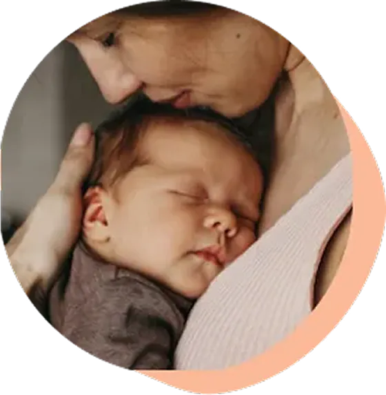 A new mother holds her baby before getting pelvic floor physical therapy.