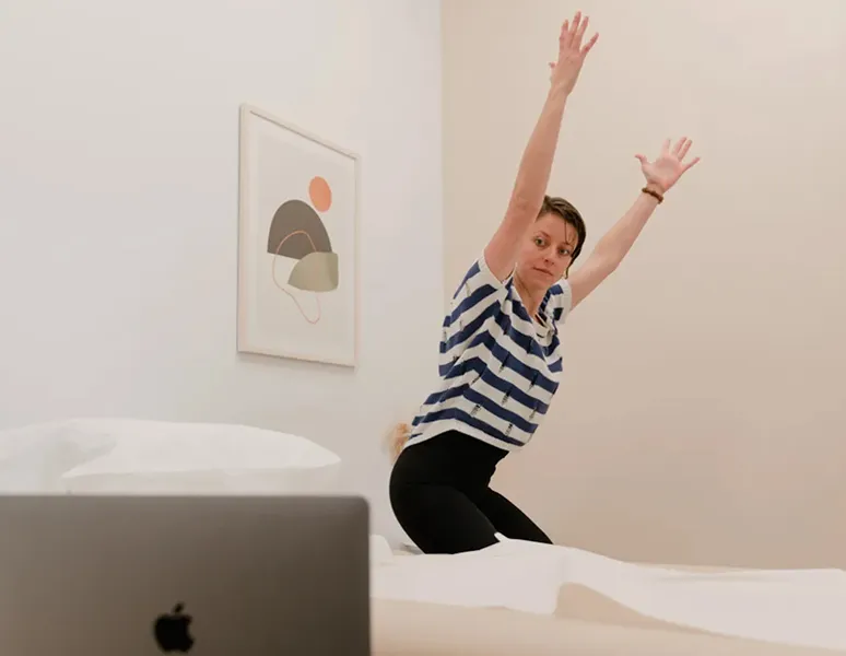 An Origin physical therapist demonstrating an exercise during a virtual visit.