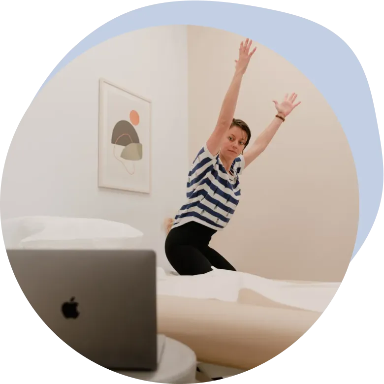 An Origin physical therapist demonstrating an exercise during a virtual visit.