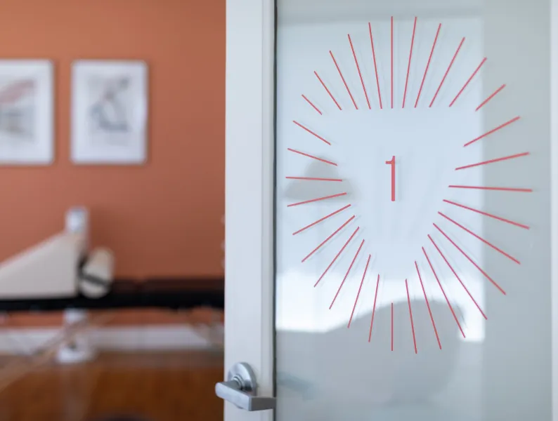 Art on a treatment room door at one of Origin’s beautifully designed clinics.