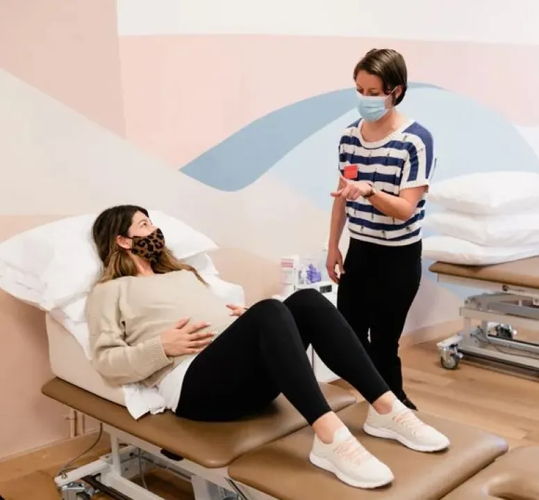 An Origin physical therapist providing in-person care at one of our spa-like clinics.