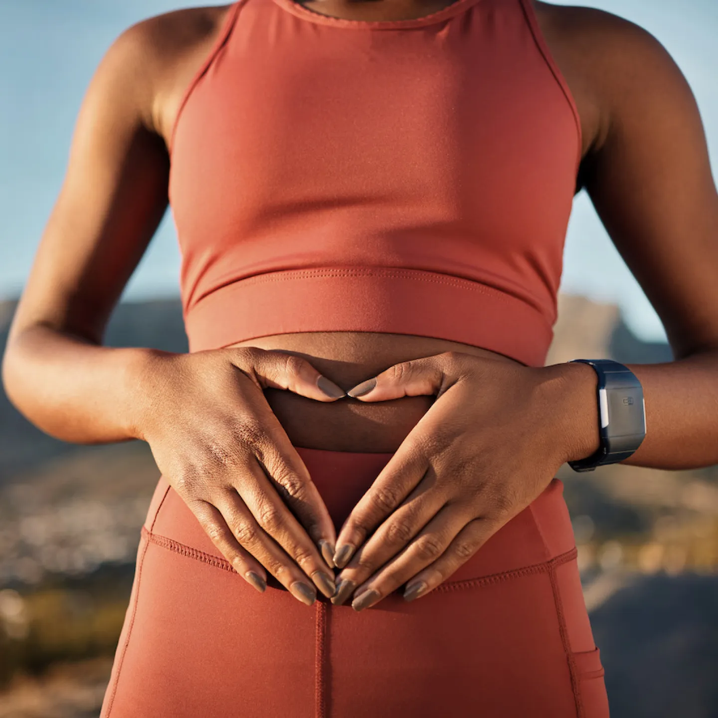 Woman holding her abdomen, representing Origin’s 2026 State of Pelvic health Report.
