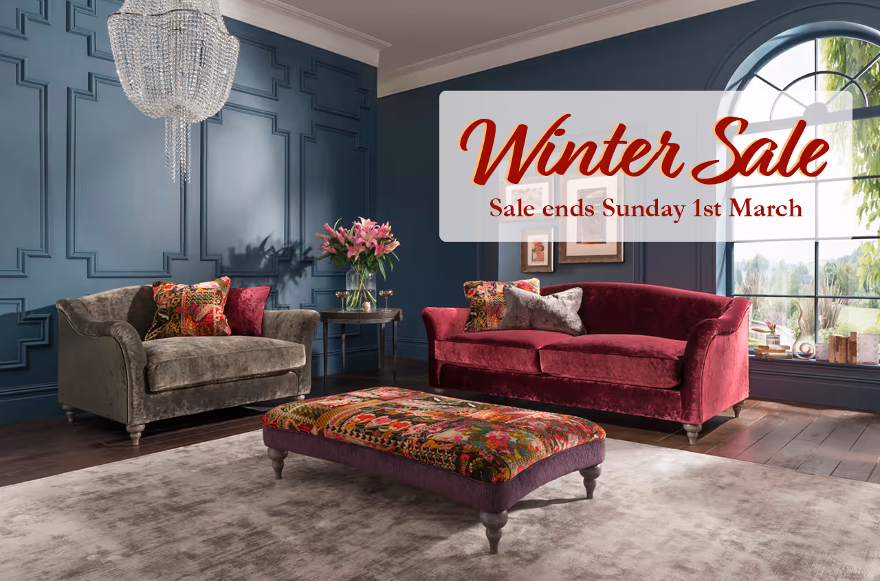 A living room with a couch a chair and a Christmas tree