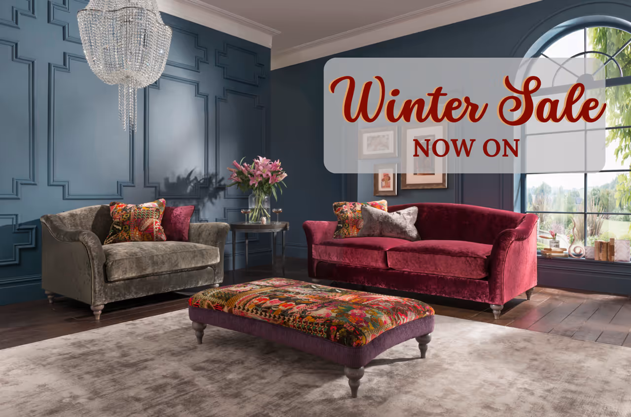 A living room with a couch a chair and a Christmas tree