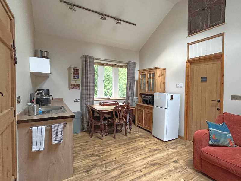 The kitchen diner area in The Nook with its wooden dresser.