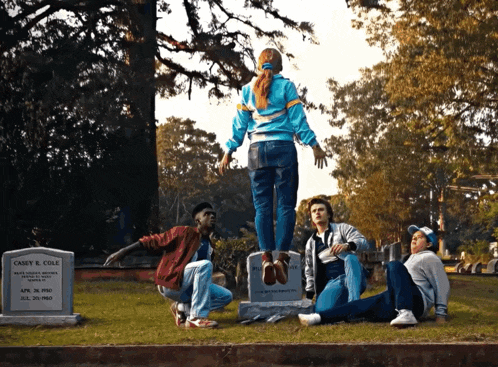a group of people are posing for a picture in front of a grave of casey cole