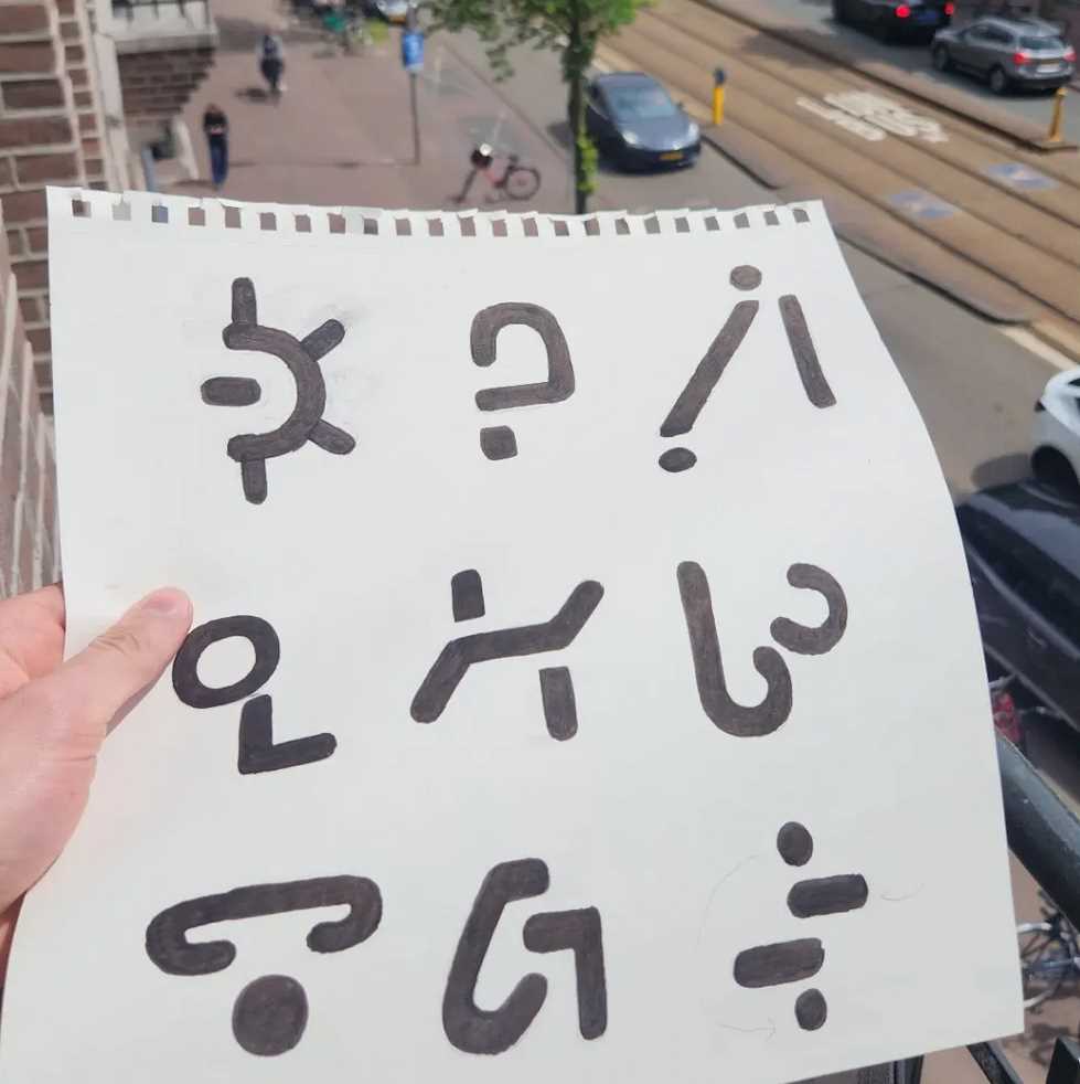 a paper with nine hand-drawn meaningless symbols