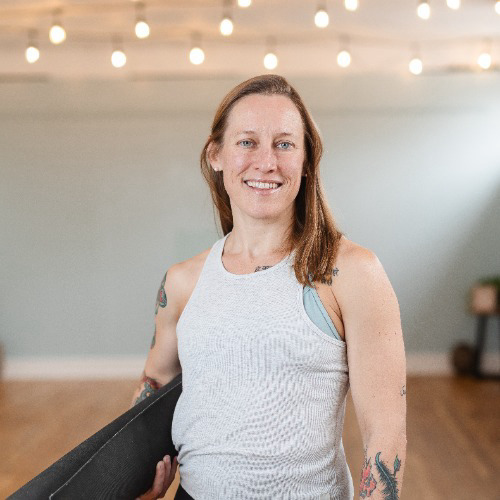 Trish Tillman has taught yoga since 2013. She initially started practicing yoga in around 2008, as a way of dealing with the physical stress and strain of her martial arts training on her body, as well as the mental strain of attending grad school. Her first class was a 90-minute hot yoga class, and ironically, her overall level of stress in her life was so high at the time that she found the 90 boiling minutes relaxing by comparison! 

Trish completed her initial yoga teacher training in 2013, at Pure Prana Yoga in Alexandria, and her advanced teacher training in 2019, at Sky House Yoga in Silver Spring, with Hari-kirtana das and Ashley Litecky Elenbaas. She has also taken a yin yoga training with Paulie Zink, as well as a training through Beloved Yoga, and restorative yoga with Tara Lemerise. 

As well as physical/ postural yoga, Trish enjoys studying and practicing bhakti yoga, the yoga of devotion, which is mentioned in the Bhagavad-Gita among the different types of yoga. She’s immersed herself in the essential texts of bhakti yoga, and the stories of bhakti yoga saints and leaders from the Middle Ages until the present. As a student of religious history, Trish is struck by how the language of devotion takes common patterns in every culture, as humans in different ages and different parts of the world all seek a meaningful relationship with the divine, and with one another. Bhakti yoga doesn’t mean seeing the world through rose-colored glasses, or being blind to bad things happening, but rather, it calls us to relate to one another authentically, and always look for opportunities to serve each other. 

Trish completed her PhD in History in 2018 at the Catholic University of America, and teaches history as an adjunct professor at University of Maryland. She has also taught college history classes at other colleges and universities in the DC area since 2012. Her writings have been published in Tarka, the print journal for Embodied Philosophy, the online yoga learning platform, and she has presented papers at conferences at Harvard Divinity School and at Notre Dame. Trish sits on the external advisory board for Harvard Divinity School’s Program for the Evolution of Spirituality, a groundbreaking program at Harvard which seeks to bring together scholars of religion and spirituality, and practitioners of those same traditions.

In Trish’s view, she’s seen spiritual practitioners look down on academics a bit as being all head and no heart, but neither should a balanced yoga student be all heart and no head. Yoga calls us to reunite the warring parts of ourselves back together, not silo ourselves off into different personas for each of our roles in life. What we are is ultimately bigger than this or that title we hold, and how we make one another feel is the most important thing of all. 
