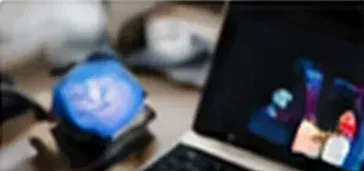 Laptop and camera hardware on a desk during computer vision work