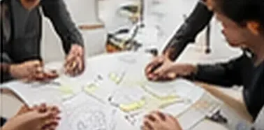 Designers sketching interface ideas together at a table