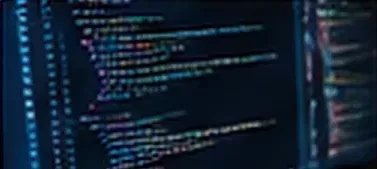 Source code on a monitor in a dark room