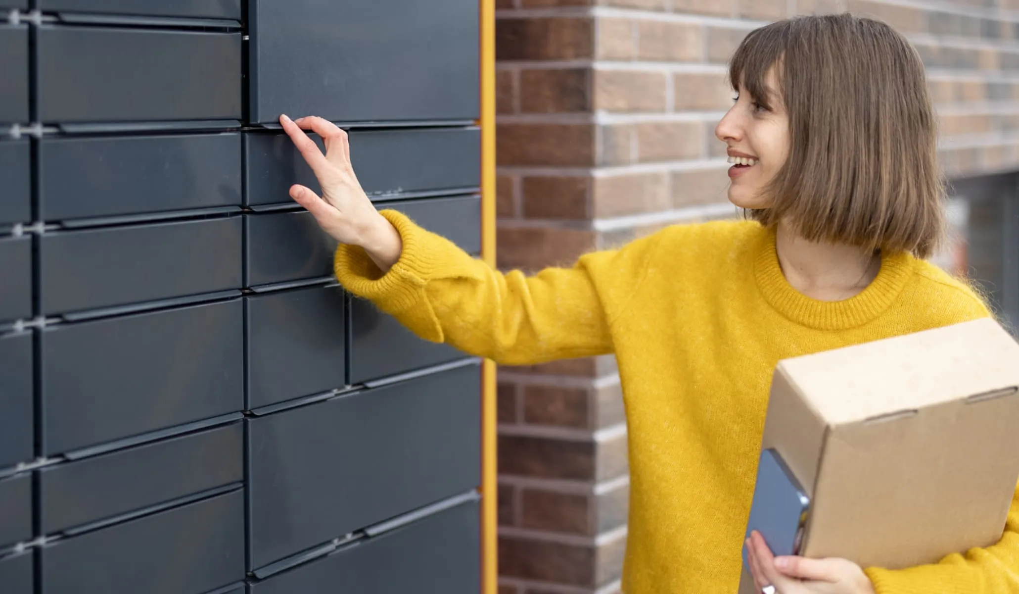 A woman ringing the doorbell with a cardboard box in her hands