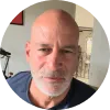 A man with a bald head wearing a blue shirt