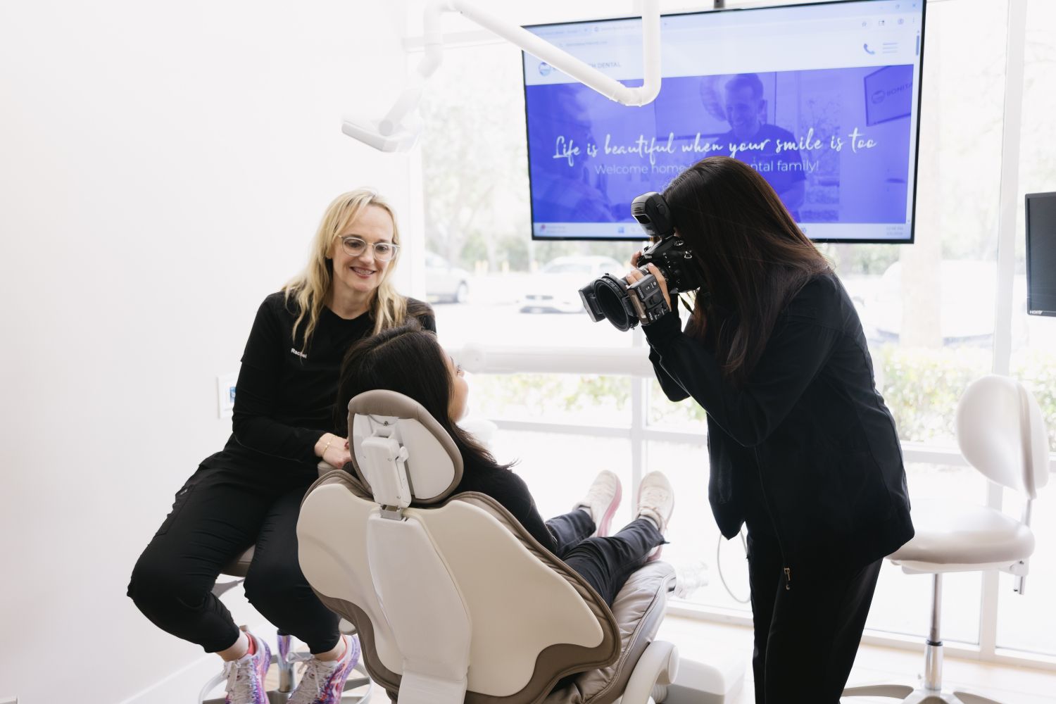 Photo of a team member looking at a patient's teeth