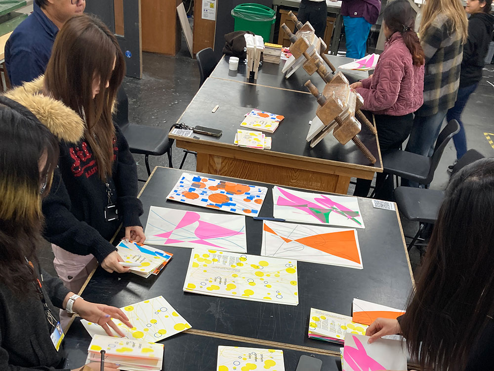Workshop participants collating and folding their Risograph publications
