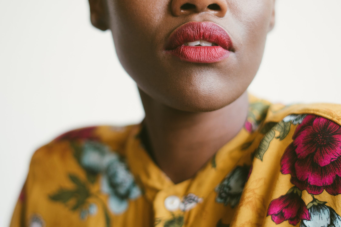 A blurred closeup of a female model's lips.