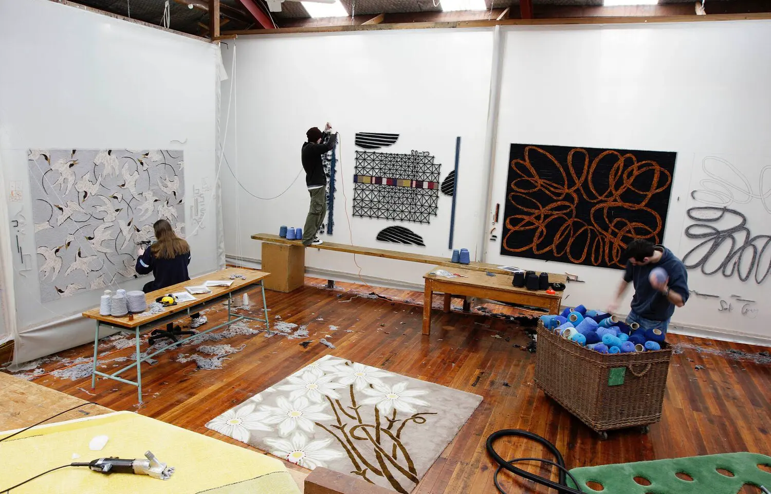 Artisan making a hand-tufted rug in the Dilana workshop