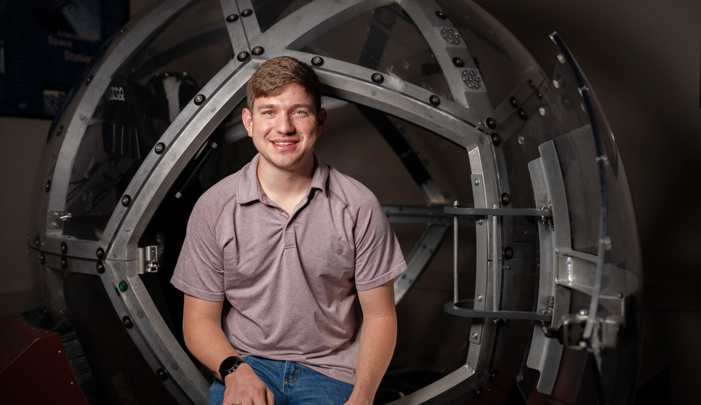 John Hayes, sitting on the entrance to the Eight360 NOVA motion base