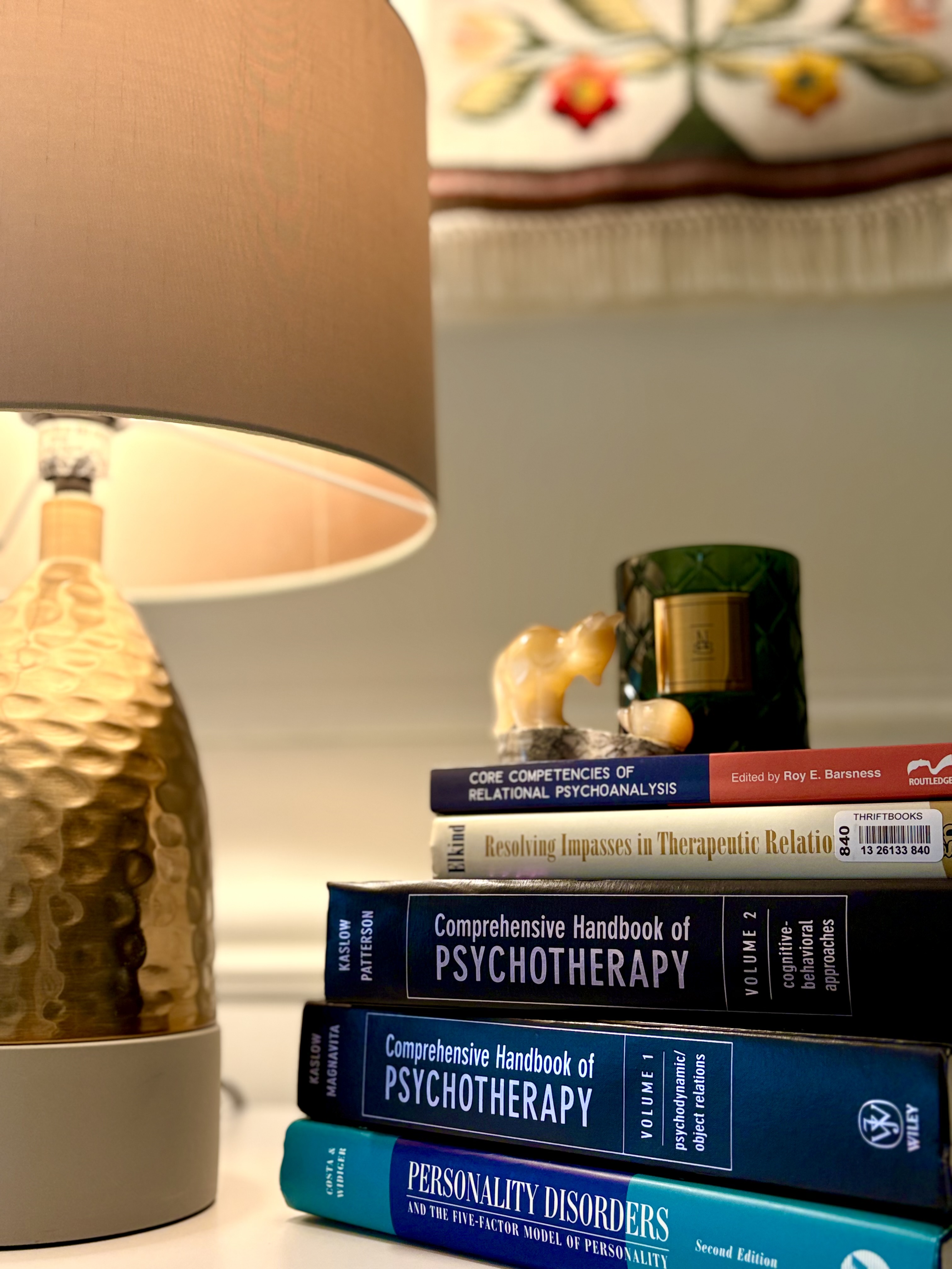 Stacked books about psychotherapy on a table