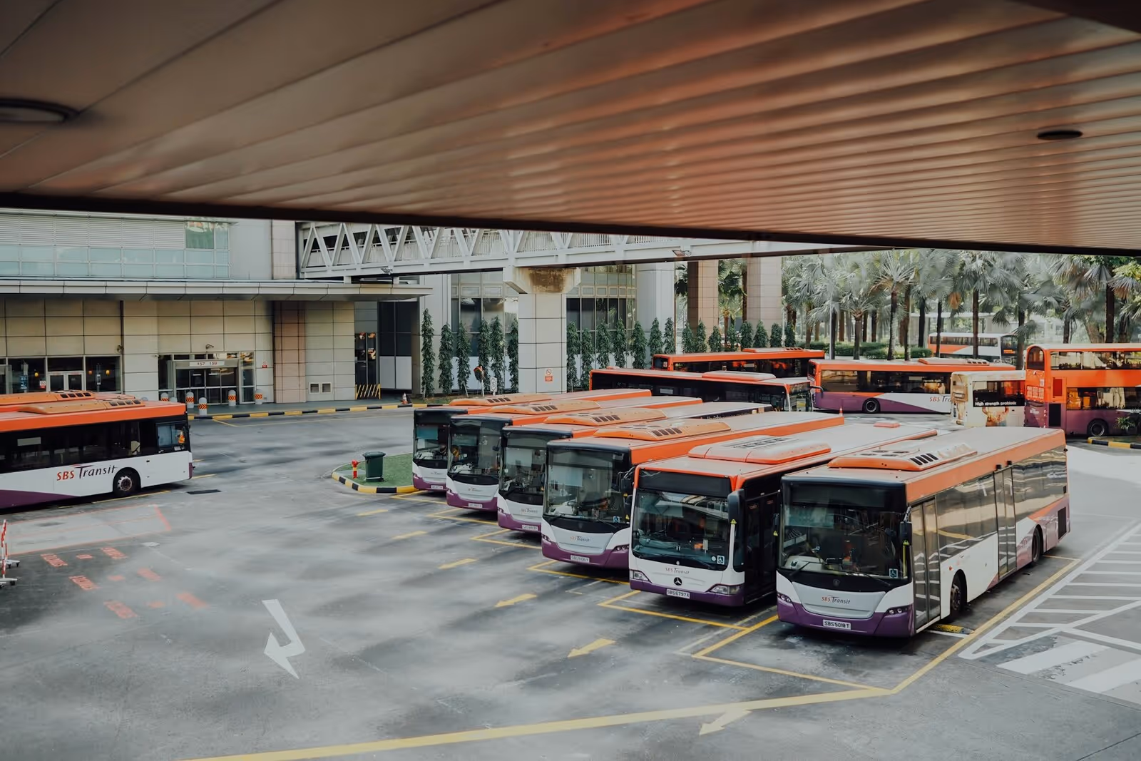 several buses parked in a bus station