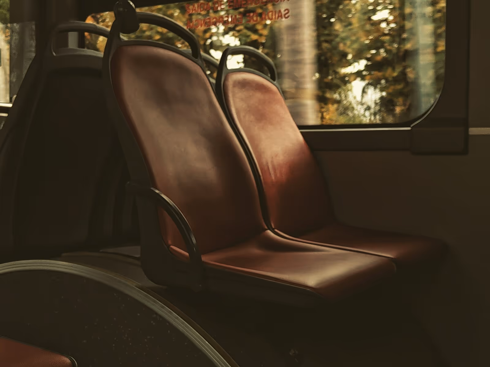view of two bus seats with window in the background