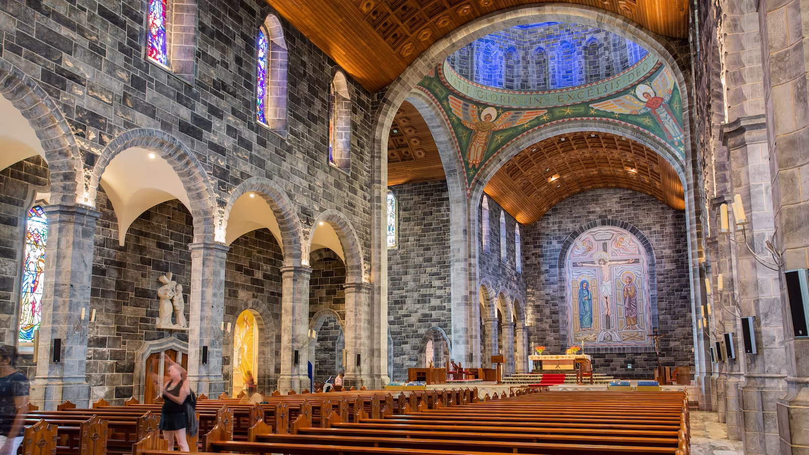 Galway Cathedral with stained glass windows and wooden pews