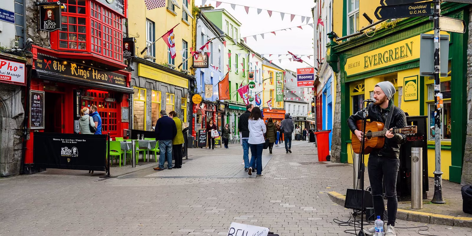 Bright buildings, people and busker in Galway