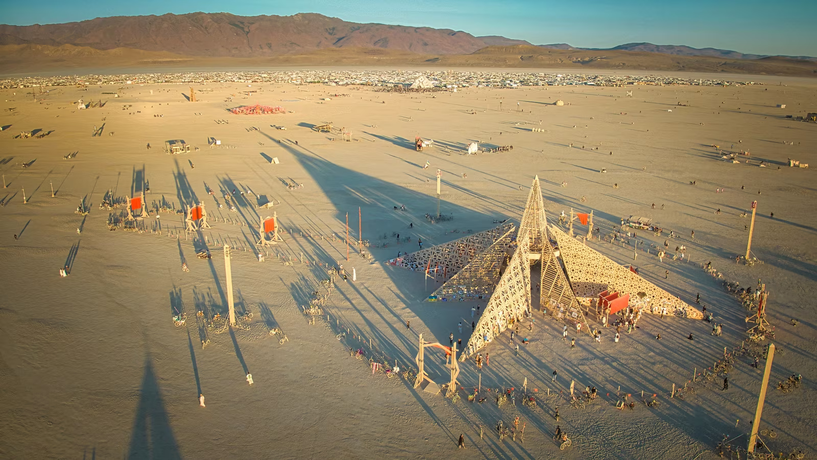 Aerial view of Burning Man in desert with mountains in background