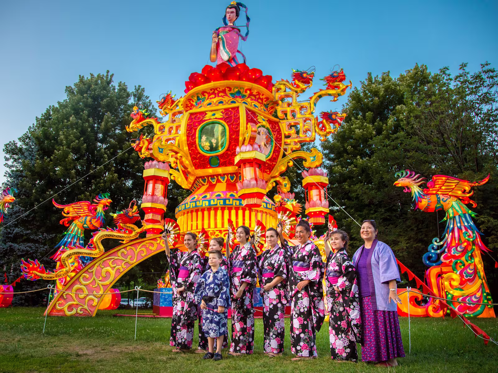 Group of performers in front of art display at lantern festival