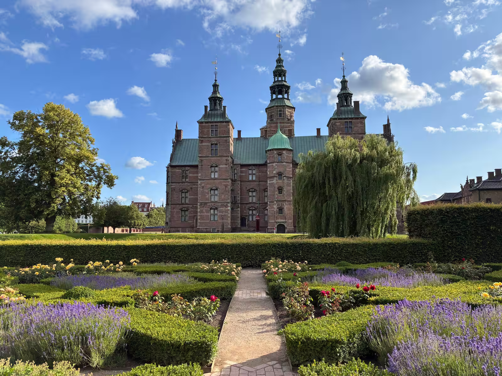 Rosenborg Castle and gardens with blue cloudy skies