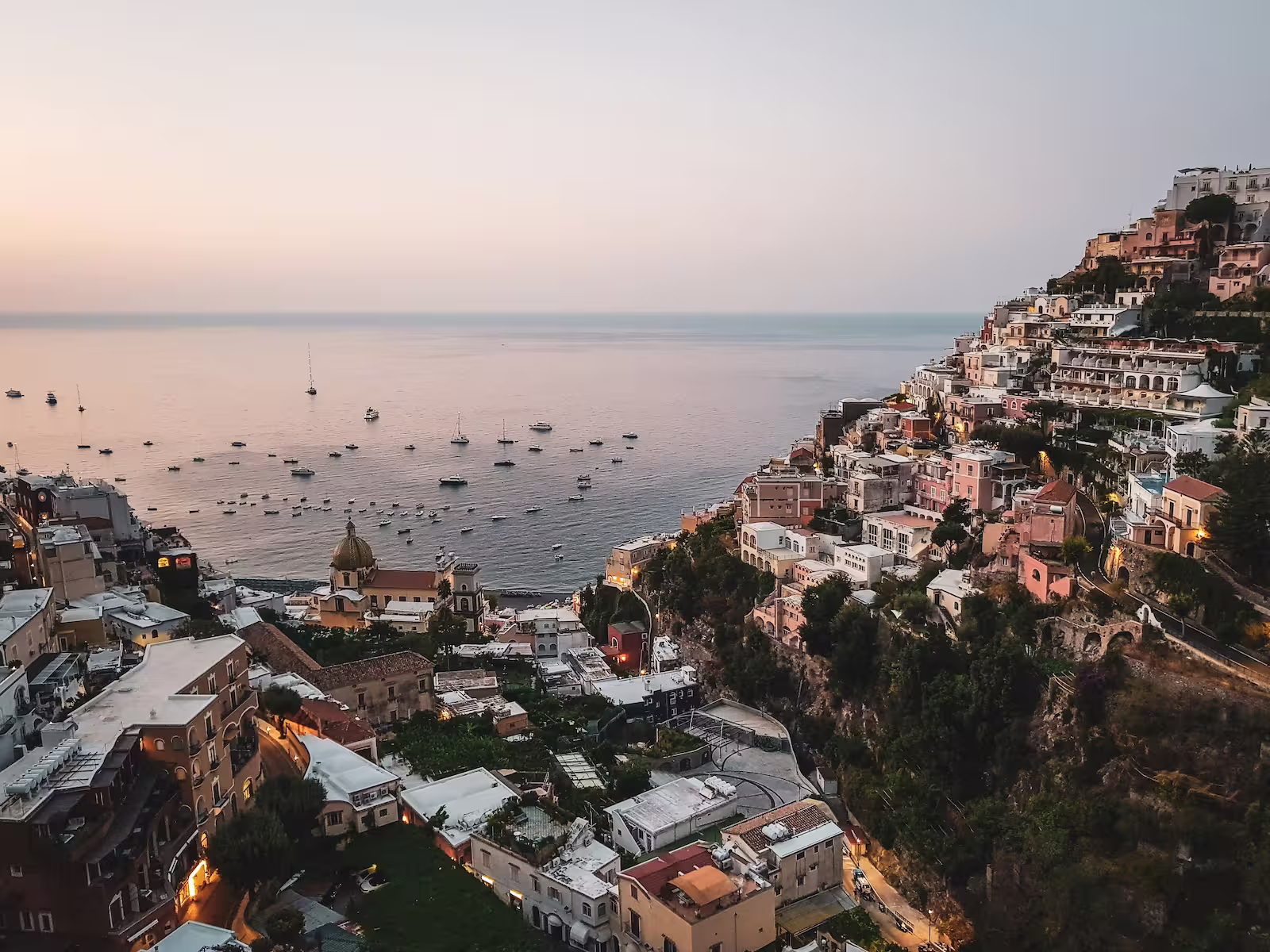 Aerial view of buildings and boats alongside coast 