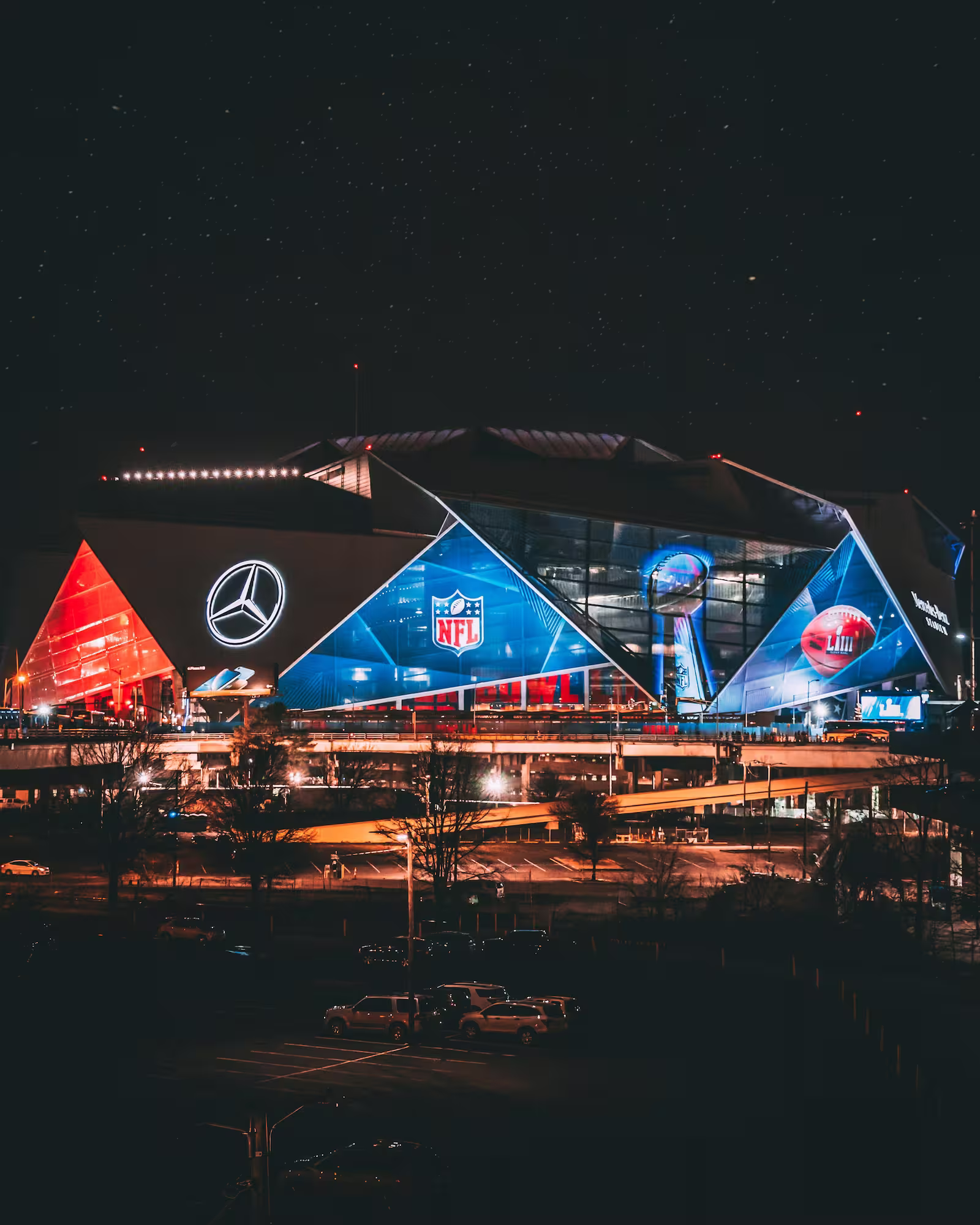 Mercedes-Benz Stadium, at night with bright signage