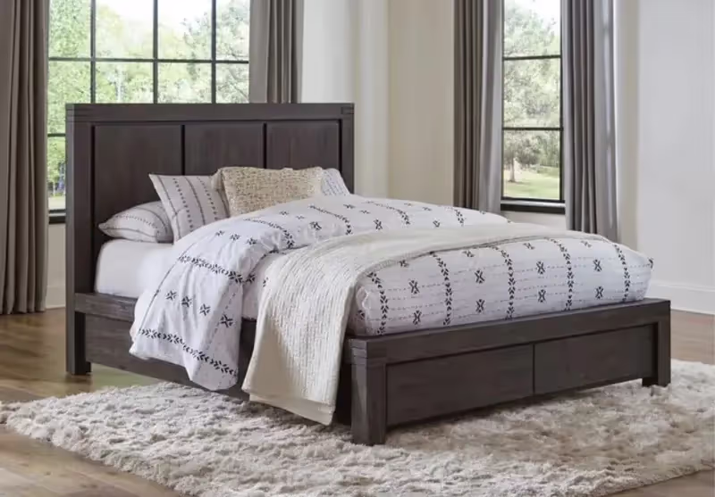 Grey solid wood bedframe with a mattress and light bedwear
