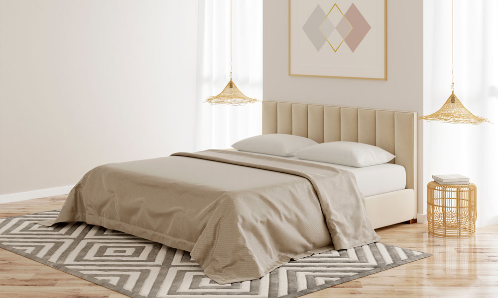 An inviting bedroom with a well-arranged bed, a decorative rug, and a lamp enhancing the ambiance.