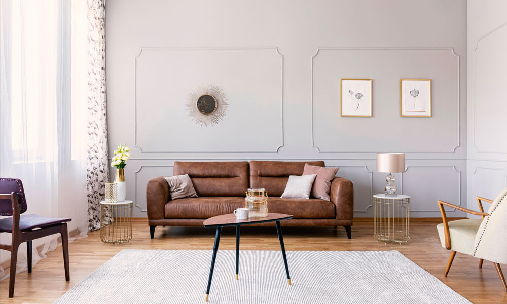 Leather sofa with wainscotting walls